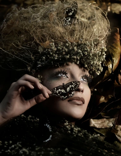 High-fashion woman with a butterfly in her face